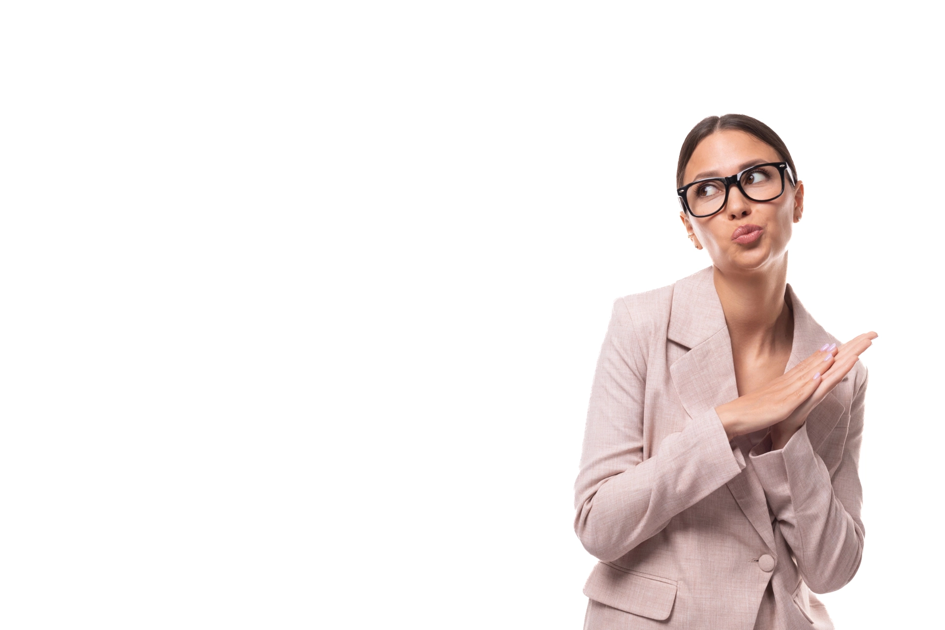 A woman in a light pink blazer and black glasses gestures with her hands, making a "time-out" sign while looking to the side, with a white background.