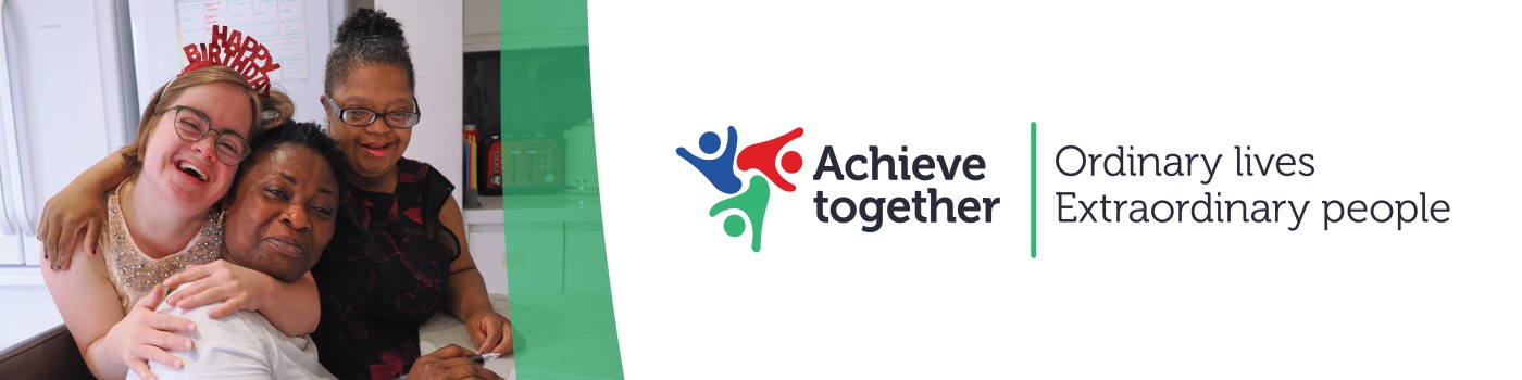 Three people smiling and hugging in a kitchen next to the Achieve Together logo and the text “Ordinary lives Extraordinary people”.