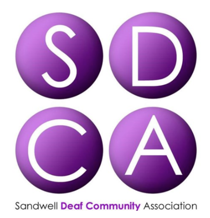 Logo with four purple circles containing white letters "S", "D", "C", and "A". Below, text reads "Sandwell Deaf Community Association".