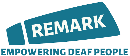 Logo featuring the word “REMARK” in bold white letters on a teal geometric shape, with the phrase “EMPOWERING DEAF PEOPLE” below in teal capital letters.